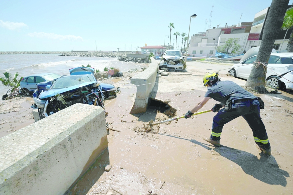 رجل إطفاء يزيل الطين من شوارع الكنار  بعد يوم من الفيضانات التي ضربت المنطقة و تسببت الأمطار الغزيرة التي استمرت لساعات في حدوث فيضانات في شرق إسبانيا .أ.ف.ب