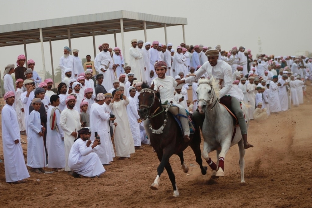 جانب من تنافس الفرسان في عرضة الخيل